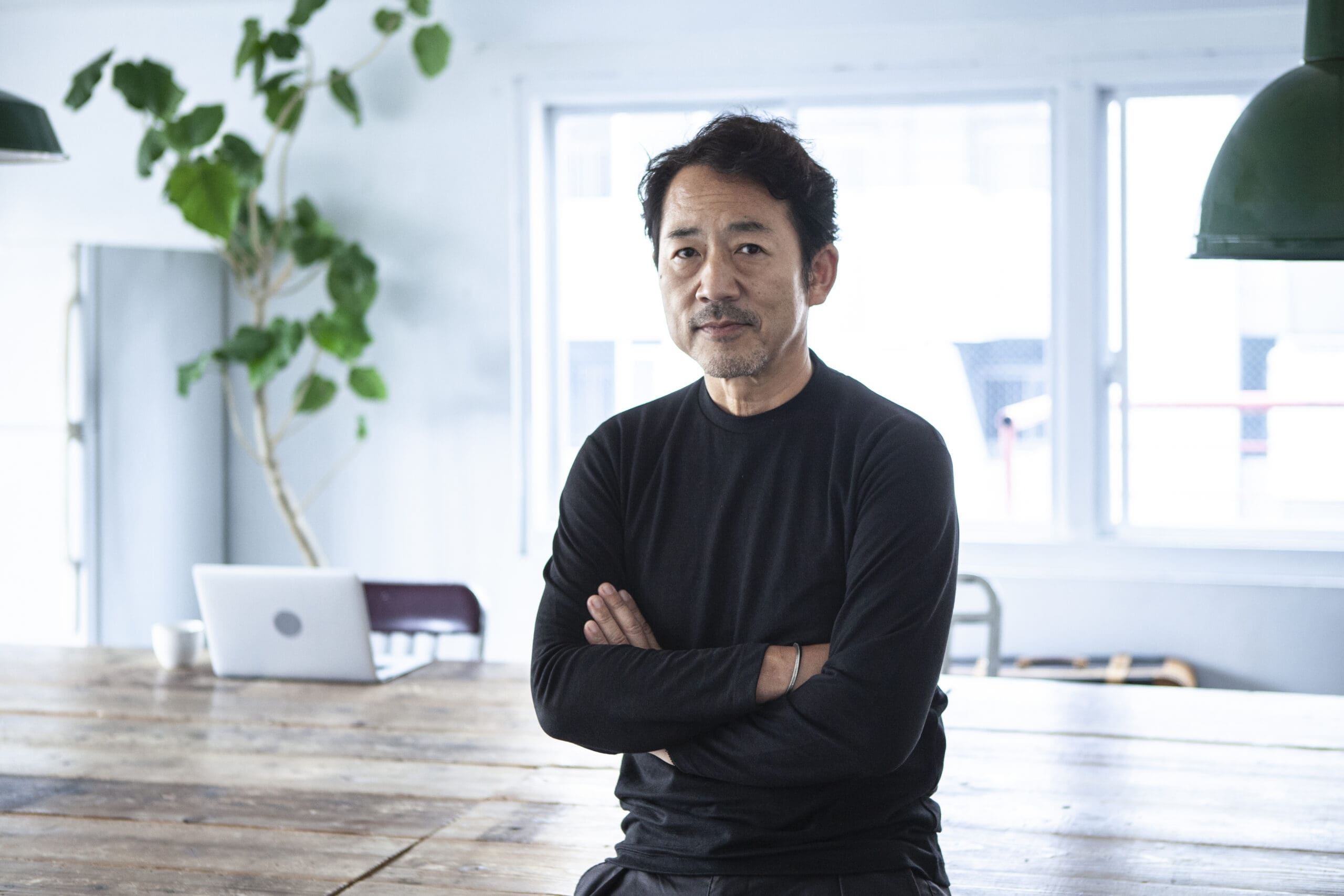 Portrait of a man looking at a camera in a modern, stylish office